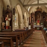 Saint Jerome Catholic Church — History, Parish Life and Patron Saint 2 Sanctuary and nave of Saint Jerome Catholic Church with altar and stained glass windows (AI Generated Image)